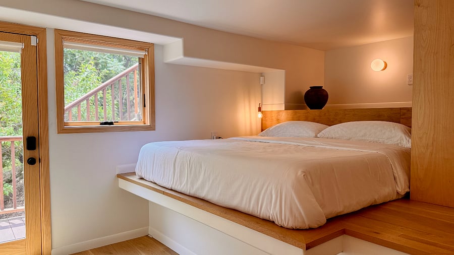 Lofted bedroom space features a premium king-sized Nectar memory foam mattress, king-sized hybrid supportive memory foam pillows and high-thread count Egyptian cotton linens.