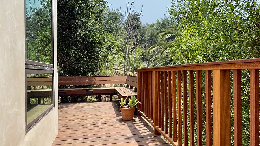 Expansive hardwood lower-level deck for exclusive use, features built-in bench seating.