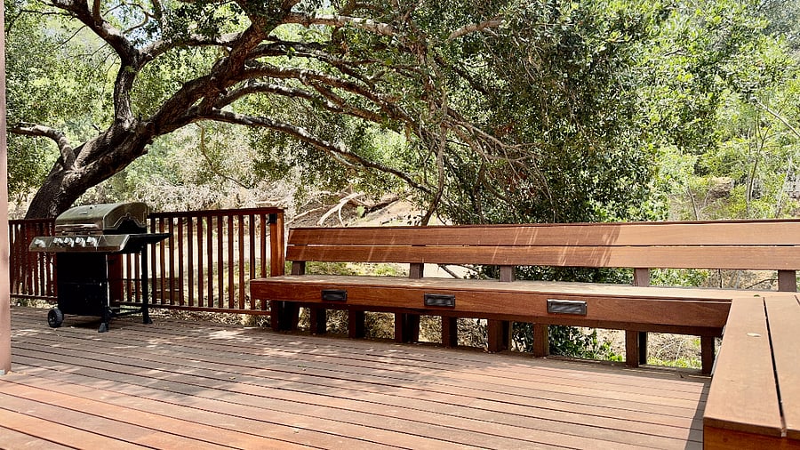 Expansive hardwood lower-level deck for exclusive use, features built-in bench seating.