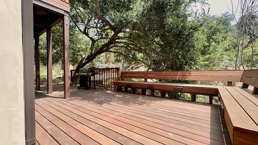 Expansive hardwood lower-level deck for exclusive use, features built-in bench seating.
