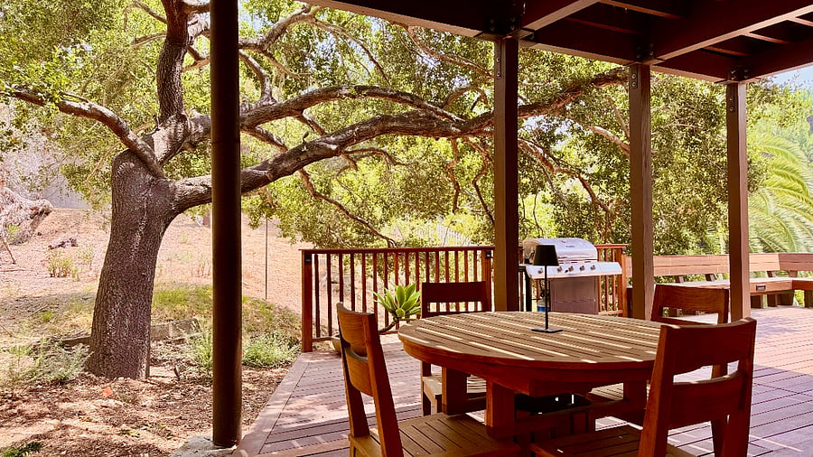 Expansive hardwood lower-level deck for exclusive use, features built-in bench seating.