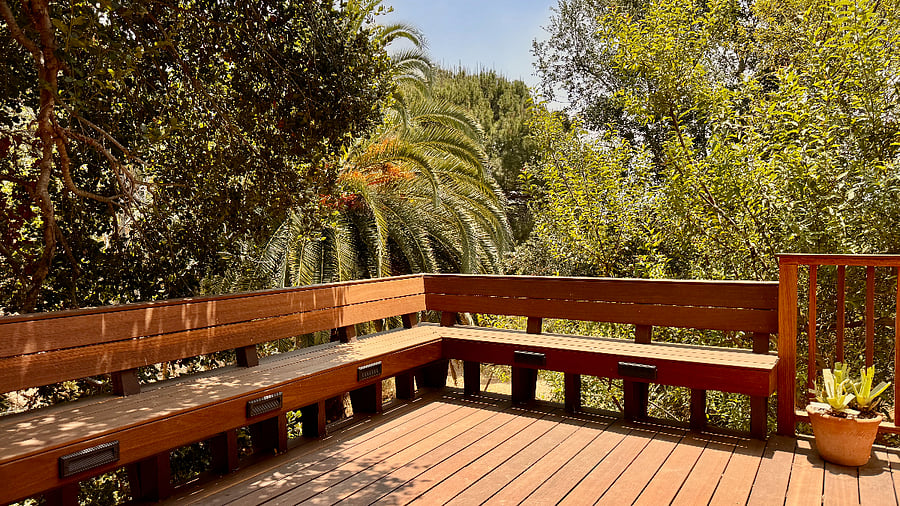 Expansive hardwood lower-level deck for exclusive use, features built-in bench seating.