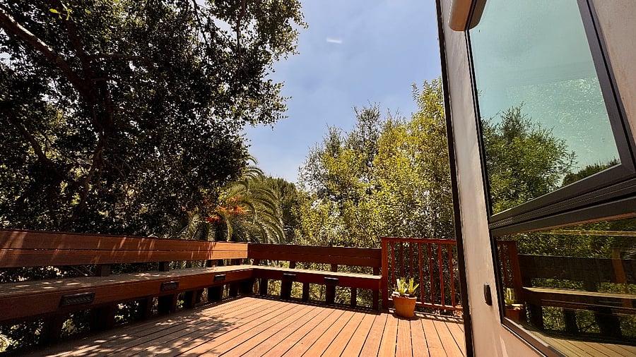 Expansive hardwood lower-level deck for exclusive use, features built-in bench seating.