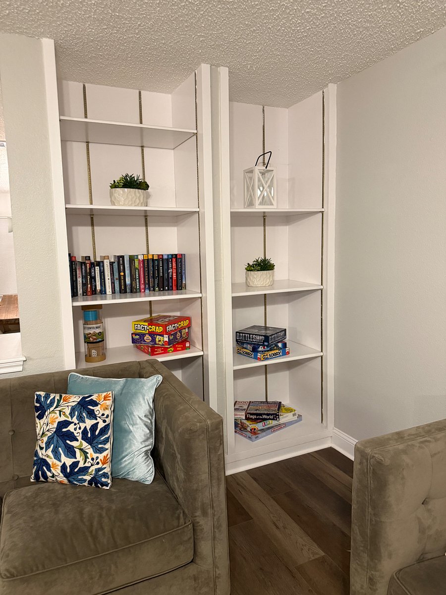 Bookshelf behind sofas in living room
