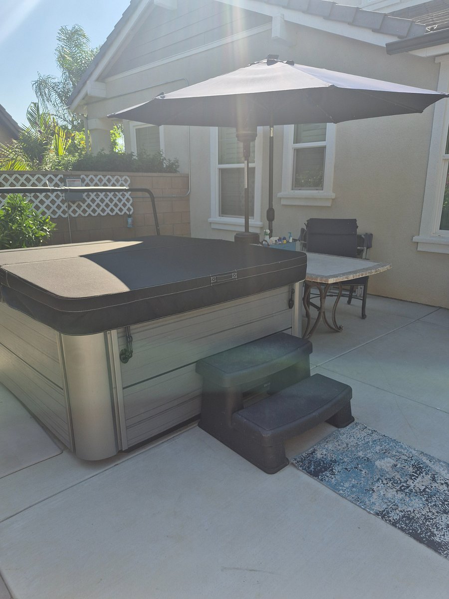 Jacuzzi, table & chairs, Umbrella that lights up at night.