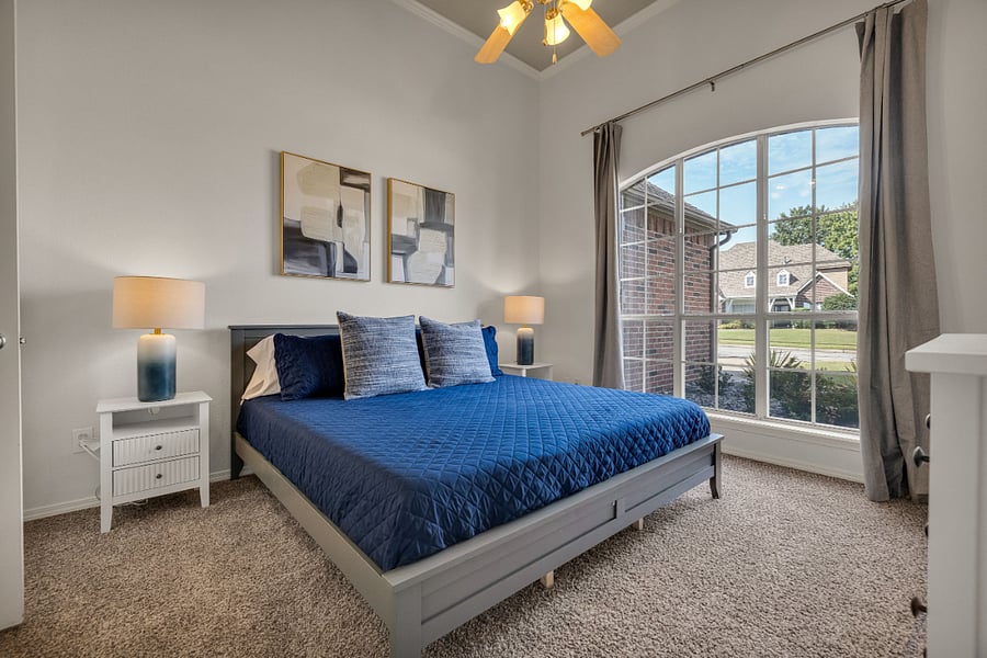 Guest bedroom with king size bed and smart tv.