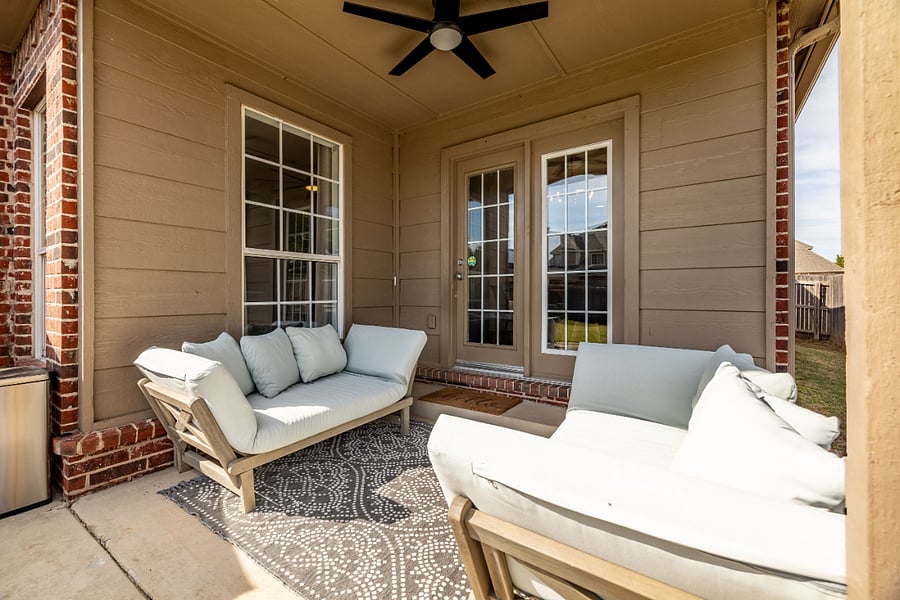 Comfortable patio furniture under covered porch.
