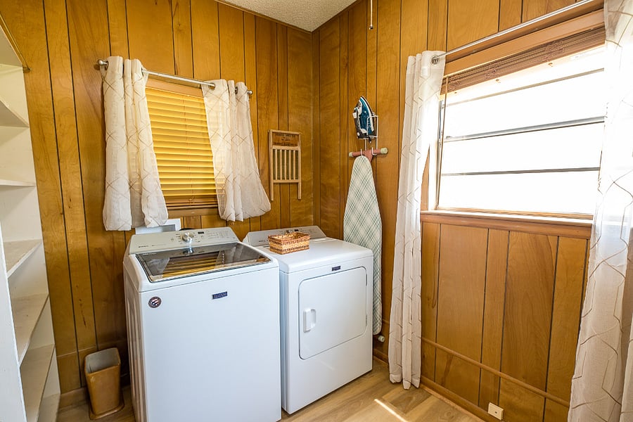 Laundry, just off of the living room and guest bedroom. It also houses the iron, ironing board, vacuum, broom, etc.