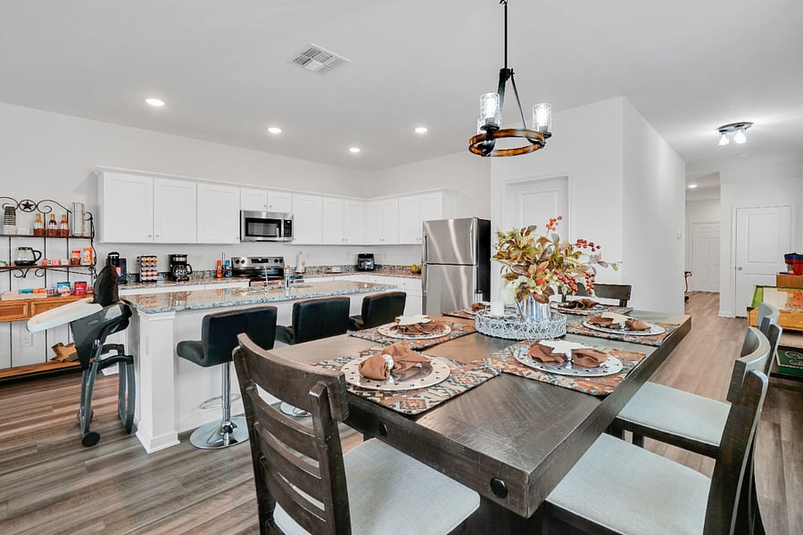 A spacious kitchen with a large island and plenty of counter space, perfect for cooking meals or gathering with family. Fully equipped and designed for convenience, its an ideal spot for prepping, serving, and enjoying time together.