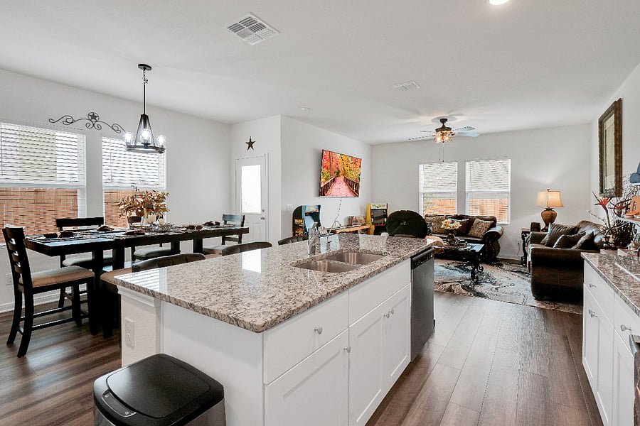 A spacious kitchen with a large island and plenty of counter space, perfect for cooking meals or gathering with family. Fully equipped and designed for convenience, its an ideal spot for prepping, serving, and enjoying time together.