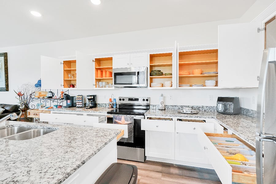 A spacious kitchen with a large island and plenty of counter space, perfect for cooking meals or gathering with family. Fully equipped and designed for convenience, its an ideal spot for prepping, serving, and enjoying time together.