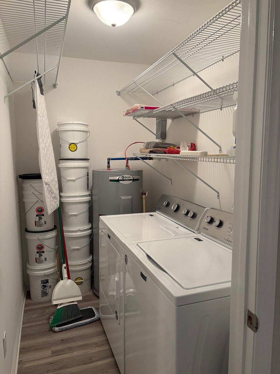 Closed-in laundry room with washer, dryer, and space to hang clothes