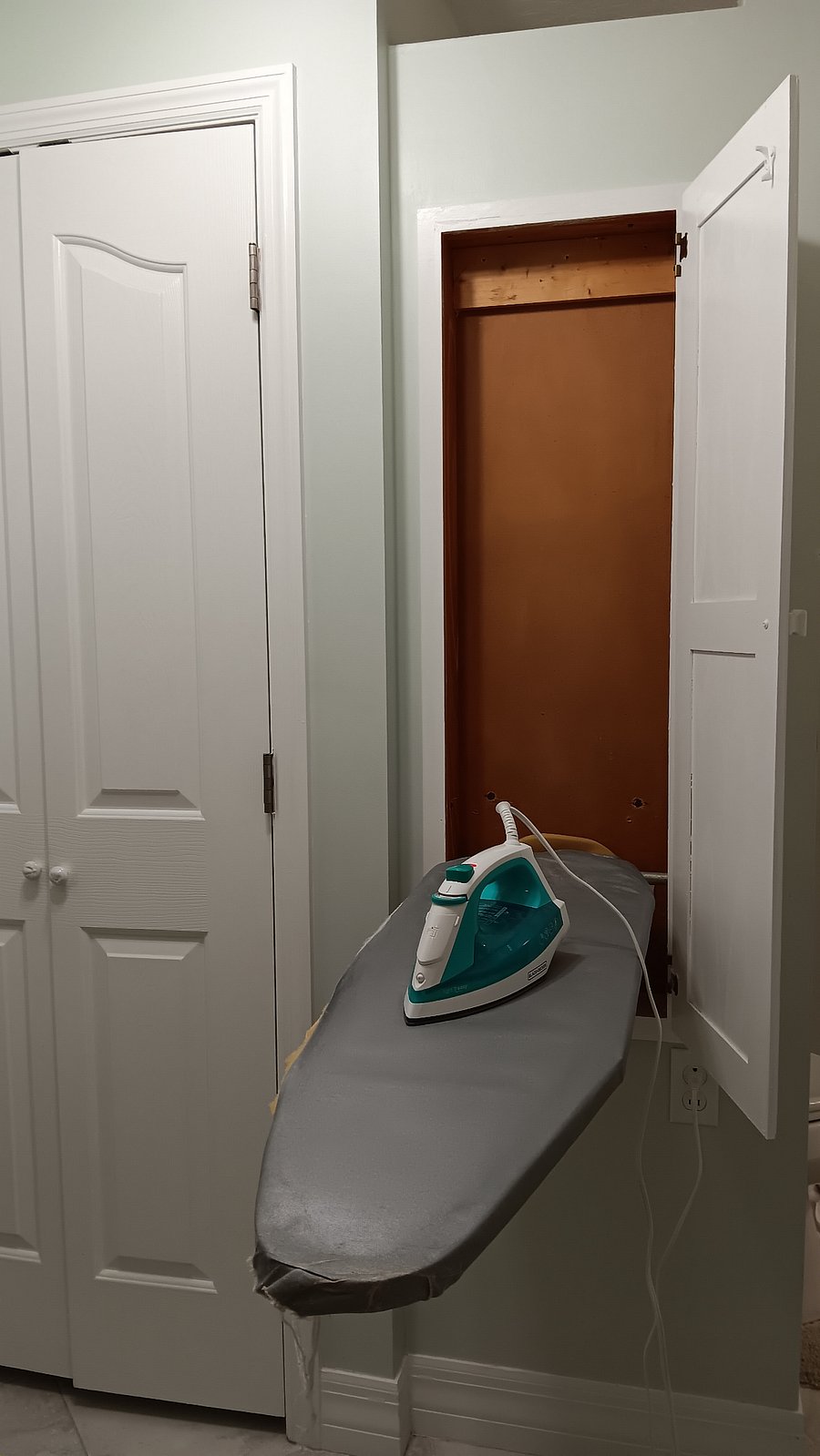Second bathroom, put-away ironing board and iron.