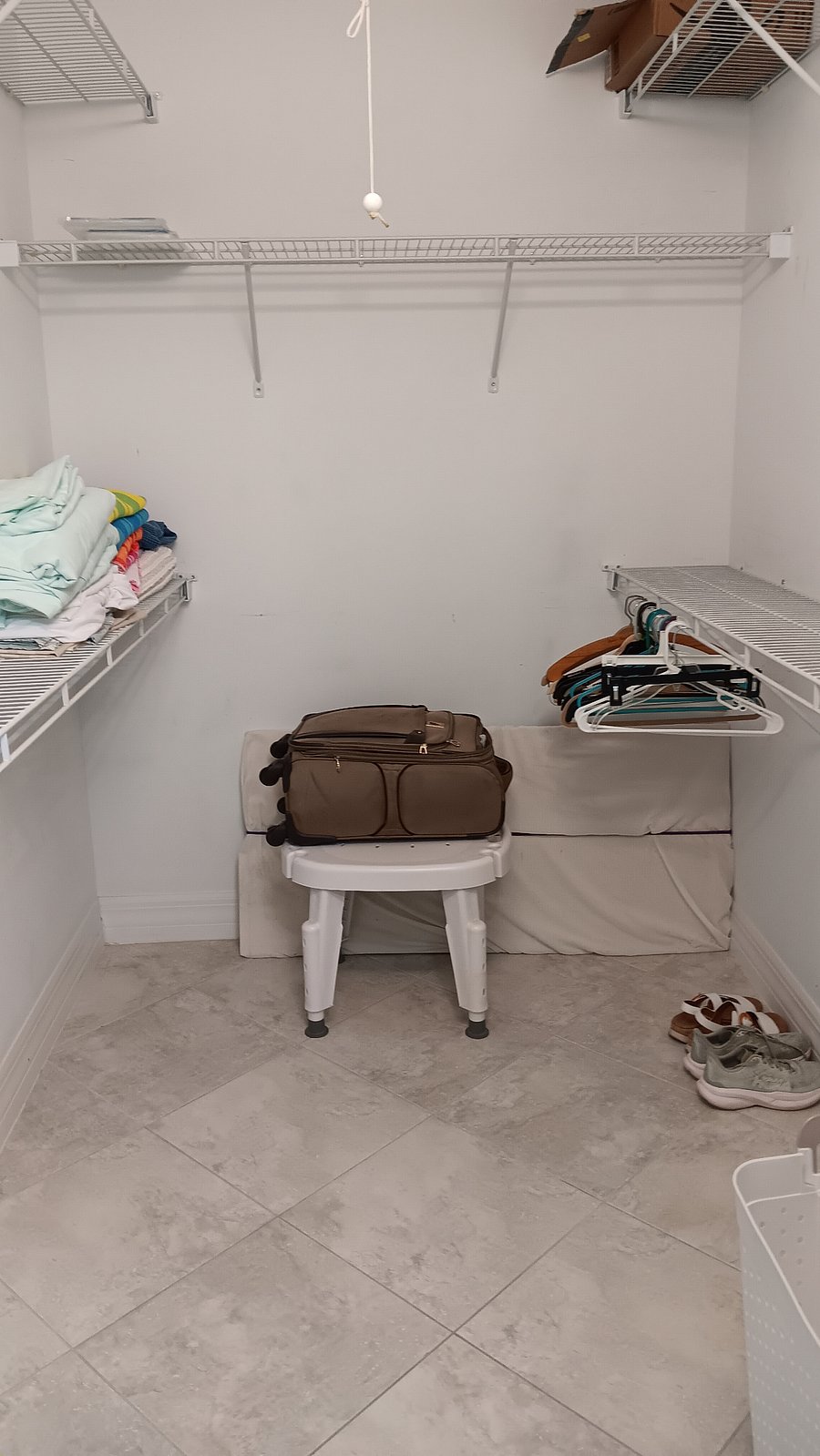 Roomy walk-in closet with shelves