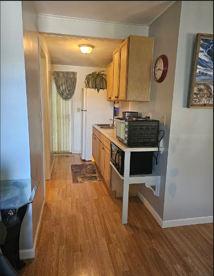 kitchenette and storage space with sliding door to outside exit with fenced in yard and Jacuzzi hot tub