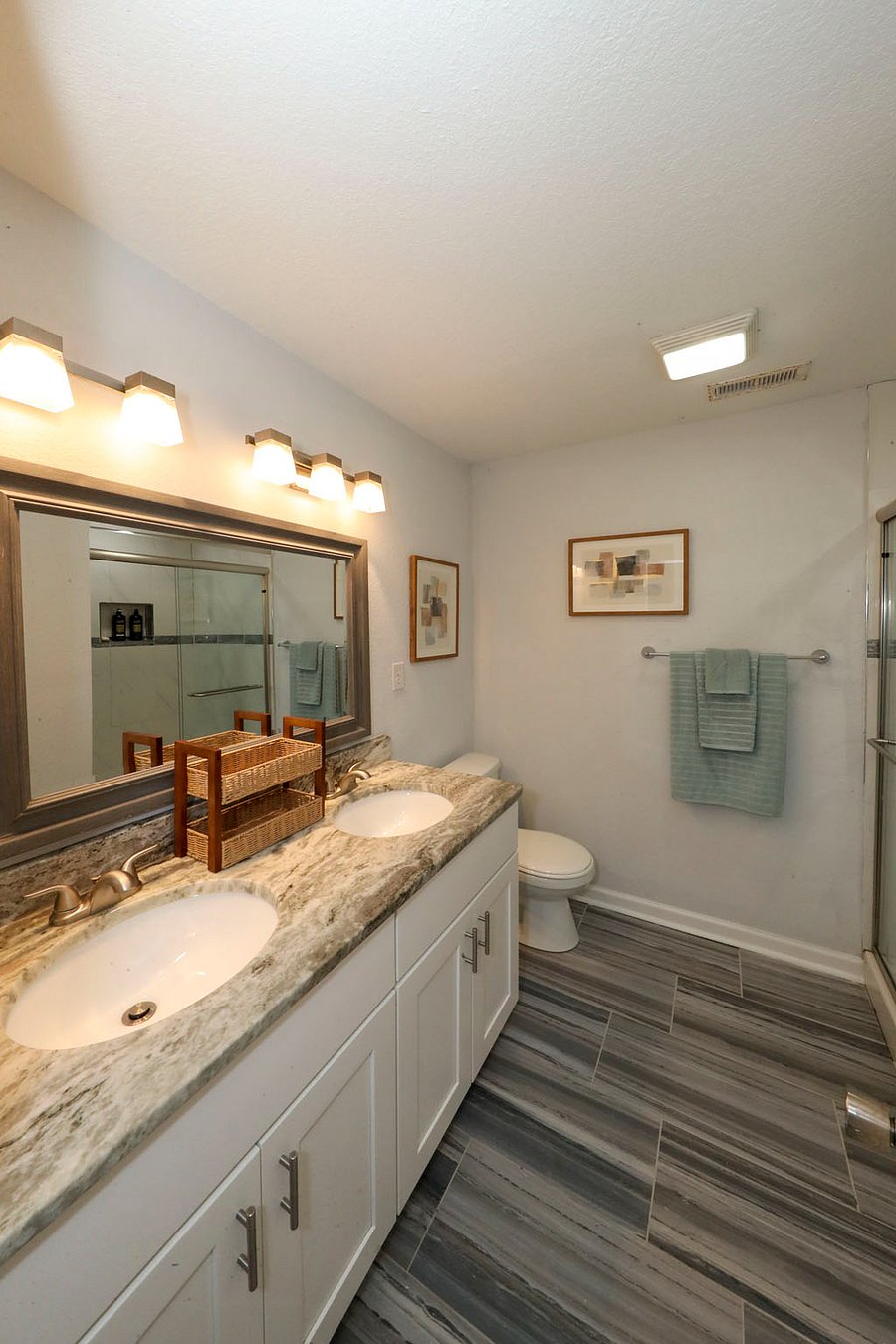 The White Sand Ensuite Bathroom
The private attached bathroom for Primary Bedroom #1 features a spacious double-sink vanity with plenty of counter space and a modern stand-up shower. Bright, clean, and perfectly designed for a seamless morning routine.