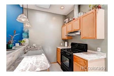 Full kitchen with dishwasher, full stove and fridge, and marble countertops. 