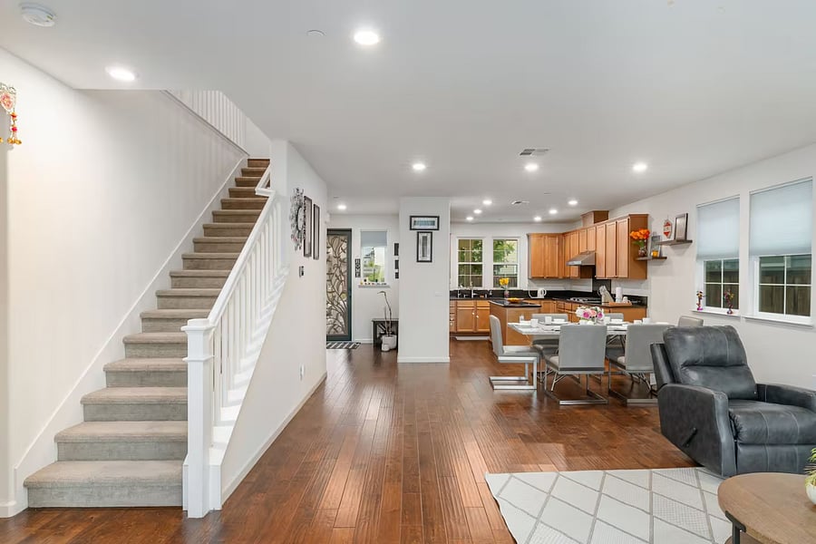 Bright open-concept living room with seamless flow from the kitchen through the dining area, creating a welcoming and spacious environment ideal for everyday living and gathering.