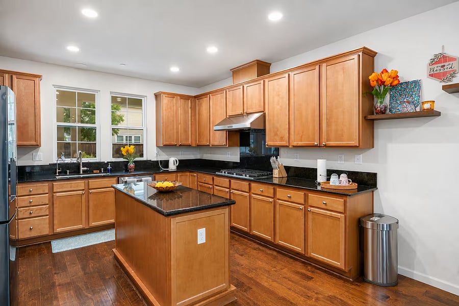 Gourmet kitchen featuring an island and premium KitchenAid appliances, including a microwave, oven, and dishwasher. A smart refrigerator adds modern convenience, making this kitchen both stylish and highly functional for everyday cooking and entertaining.