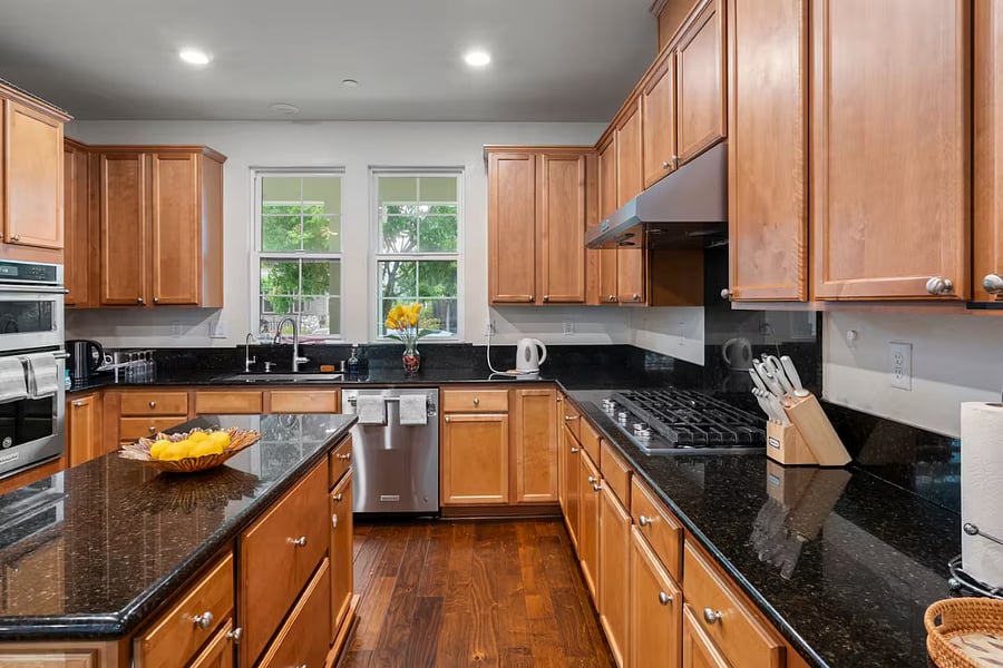 Gourmet kitchen featuring an island and premium KitchenAid appliances, including a microwave, oven, and dishwasher. A smart refrigerator adds modern convenience, making this kitchen both stylish and highly functional for everyday cooking and entertaining.