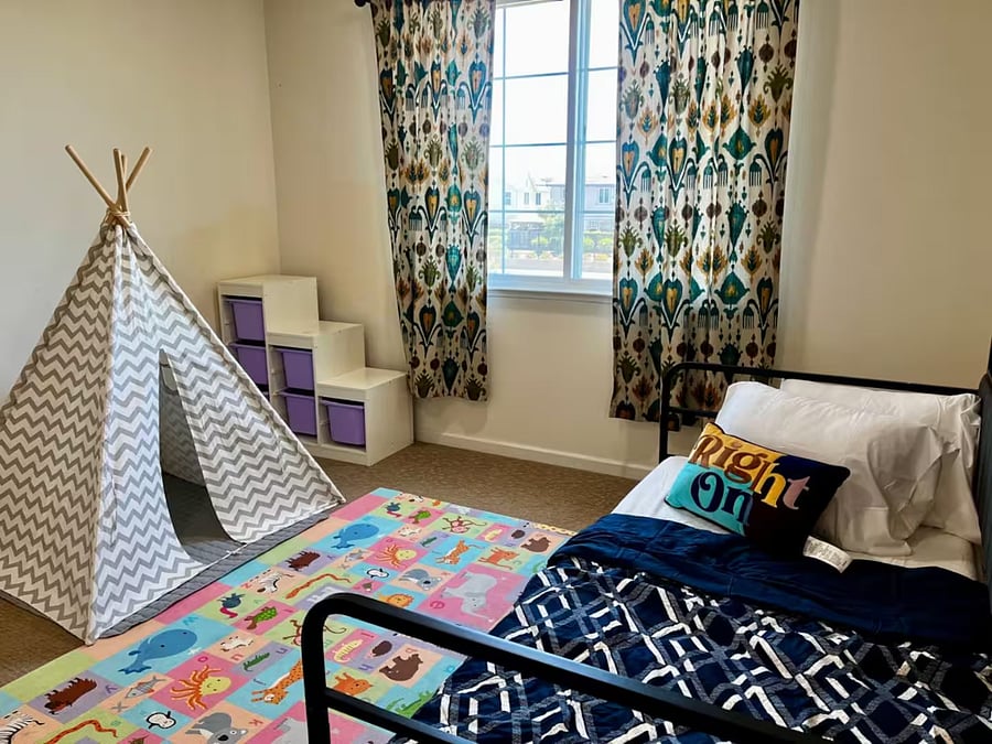 Bedroom #3  First-floor bedroom with a twin trundle bed, play mat, and toy storage, ideal for families traveling with children