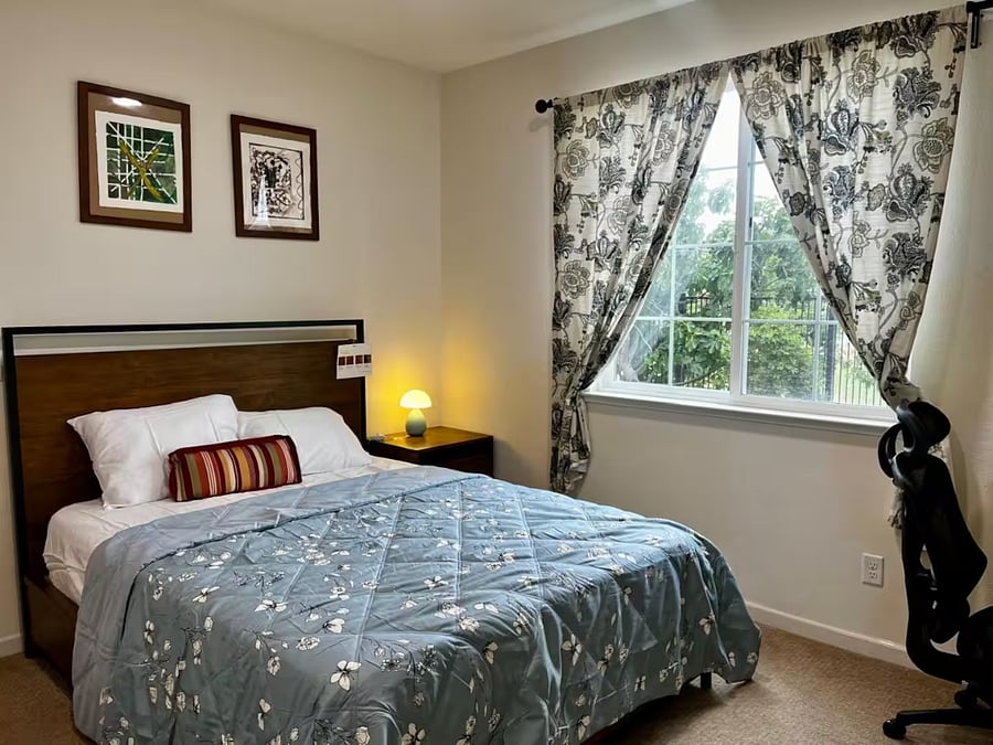 Bedroom #1- Downstairs bedroom with a Queen bed, dedicated workspace, and comfortable chair