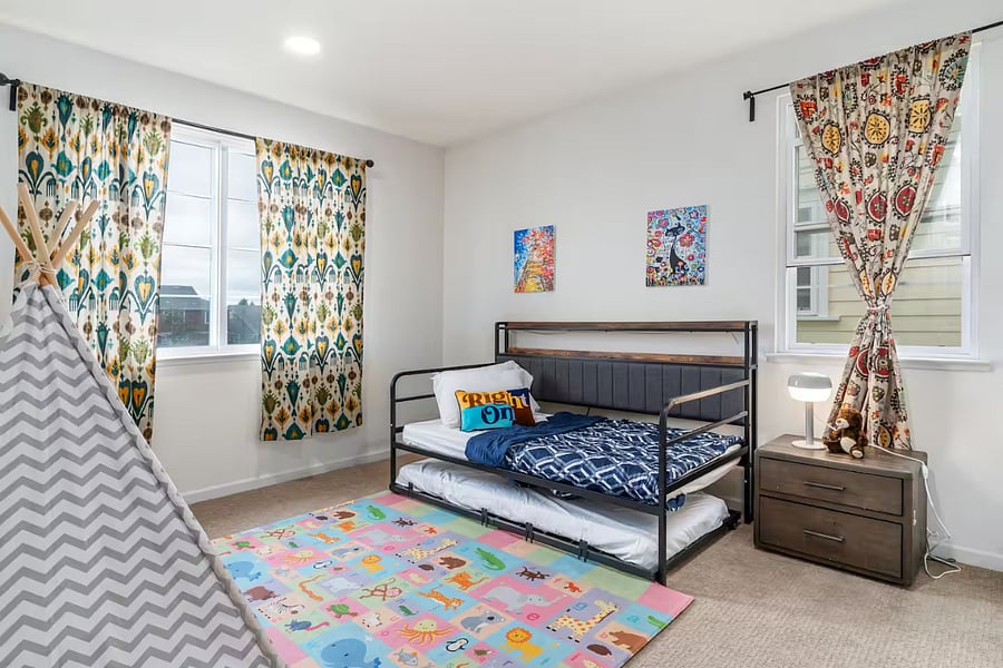Bedroom #3  First-floor bedroom with a twin trundle bed, play mat, and toy storage, ideal for families traveling with children
