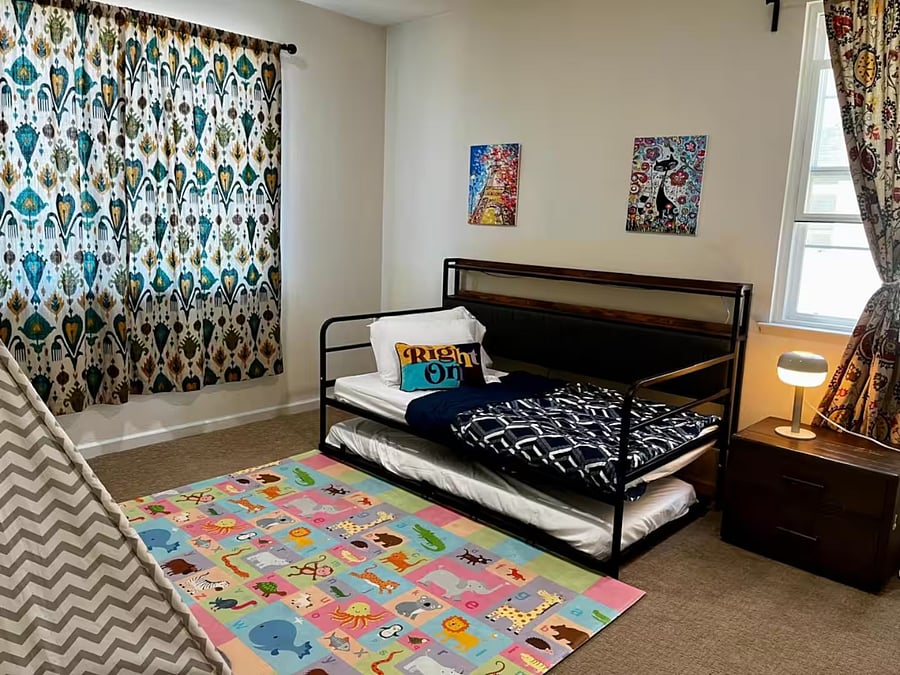 Bedroom #3  First-floor bedroom with a twin trundle bed, play mat, and toy storage, ideal for families traveling with children