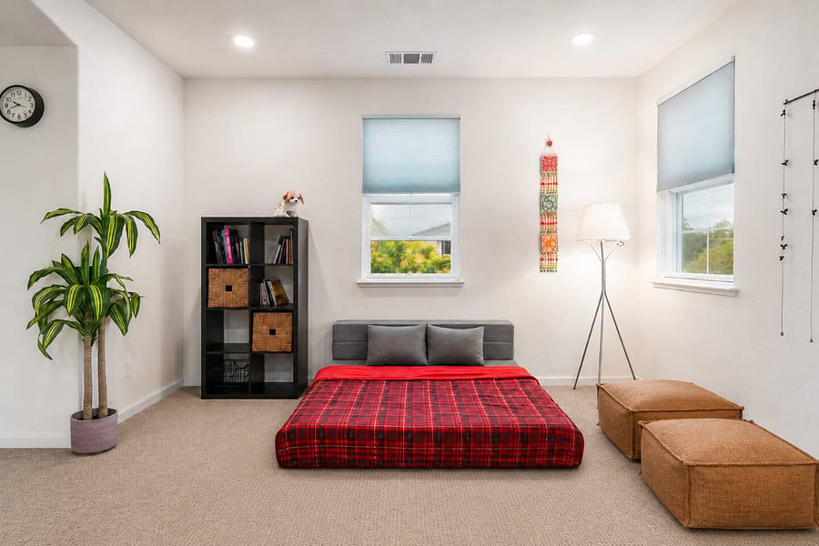 Spacious loft featuring a queen sofa-cum-bed for flexible use, cozy lounge seating, an eclectic bookshelf for relaxed reading, and ample closet