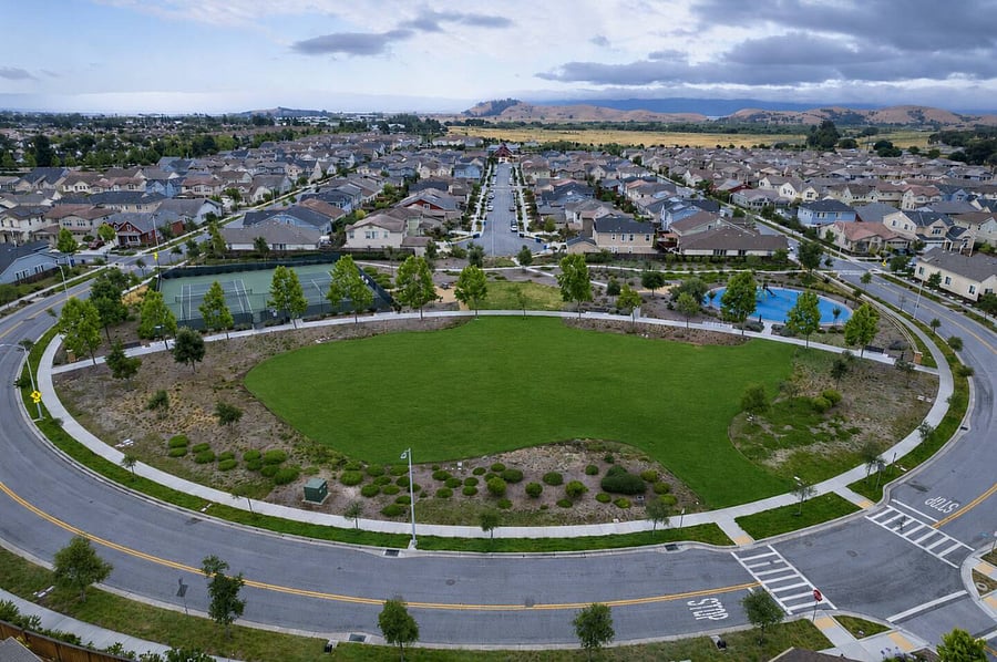 Community park featuring well-manicured green lawns and a thoughtfully designed walking path, offering a peaceful outdoor space for relaxation, strolls, and enjoying nature within the neighborhood.
