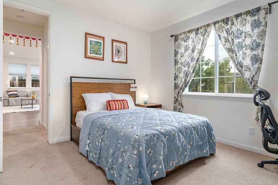 Bedroom #1- Downstairs bedroom with a Queen bed, dedicated workspace, and comfortable chair