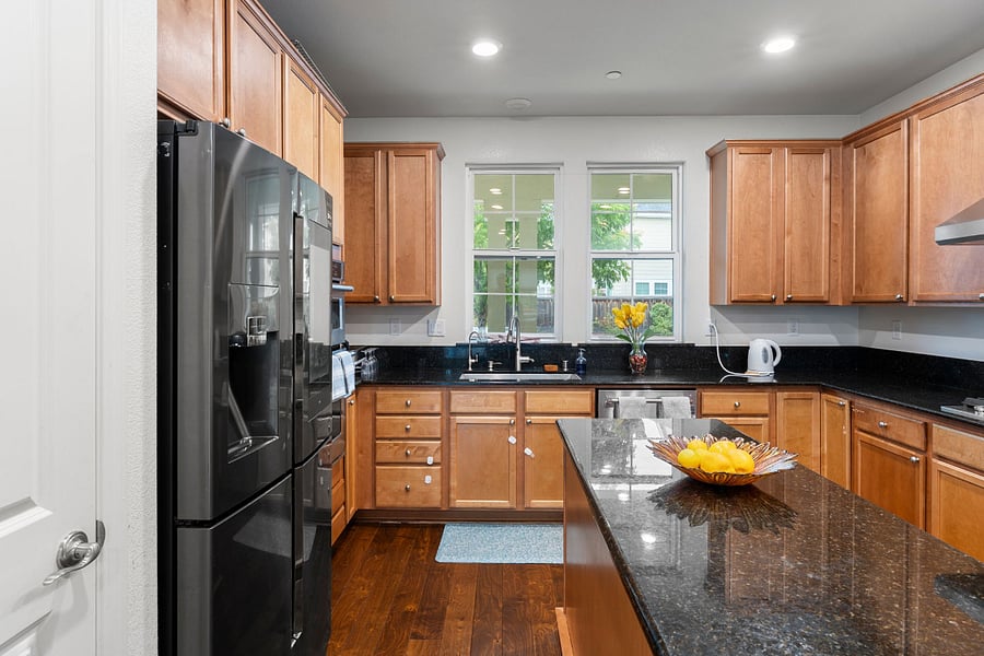 Gourmet kitchen featuring an island and premium KitchenAid appliances, including a microwave, oven, and dishwasher. A smart refrigerator adds modern convenience, making this kitchen both stylish and highly functional for everyday cooking and entertaining.