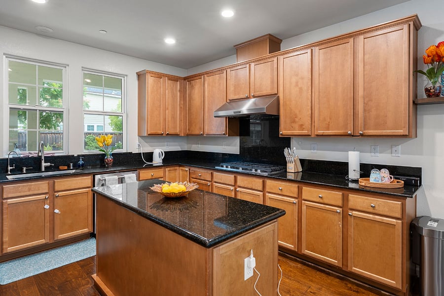 Gourmet kitchen featuring an island and premium KitchenAid appliances, including a microwave, oven, and dishwasher. A smart refrigerator adds modern convenience, making this kitchen both stylish and highly functional for everyday cooking and entertaining.