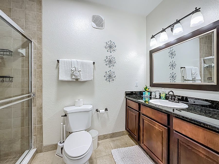 Modern rainfall showerhead and sleek tile work create a spa-like experience every morning.