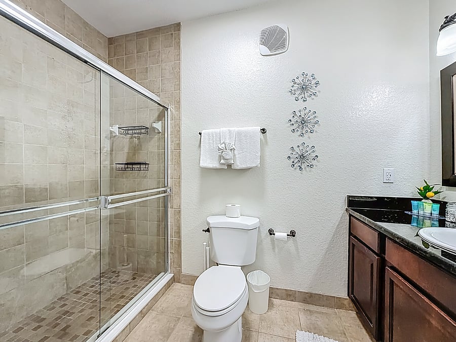 Start your day refreshed in this spacious walk-in shower with premium fixtures and plenty of natural light.