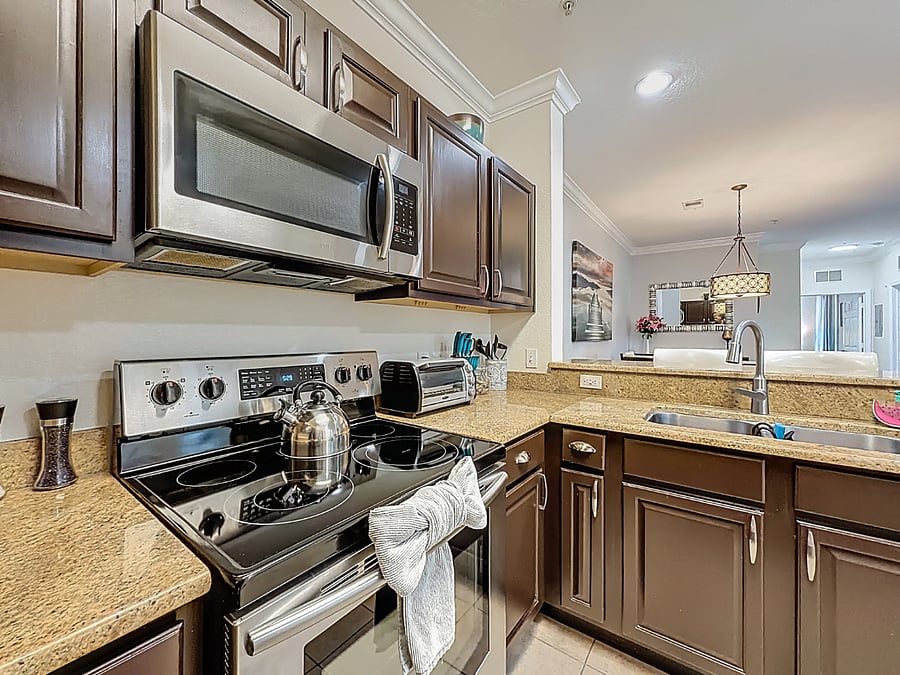 Modern stainless steel oven, fridge, and dishwasher make meal prep and cleanup a breeze.