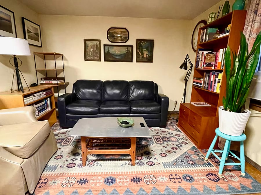 View of couch and rocking easy chair