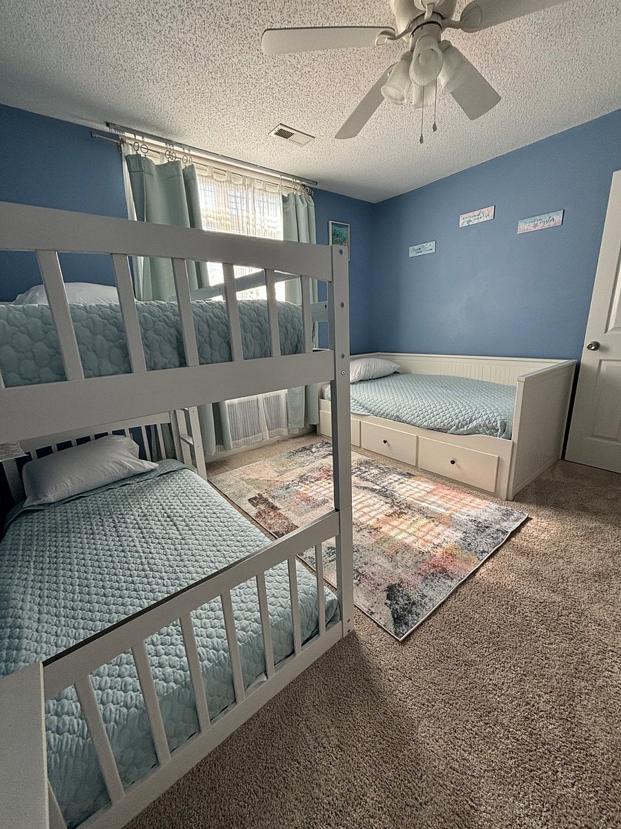 Twin bedroom with 3 twin beds and dresser