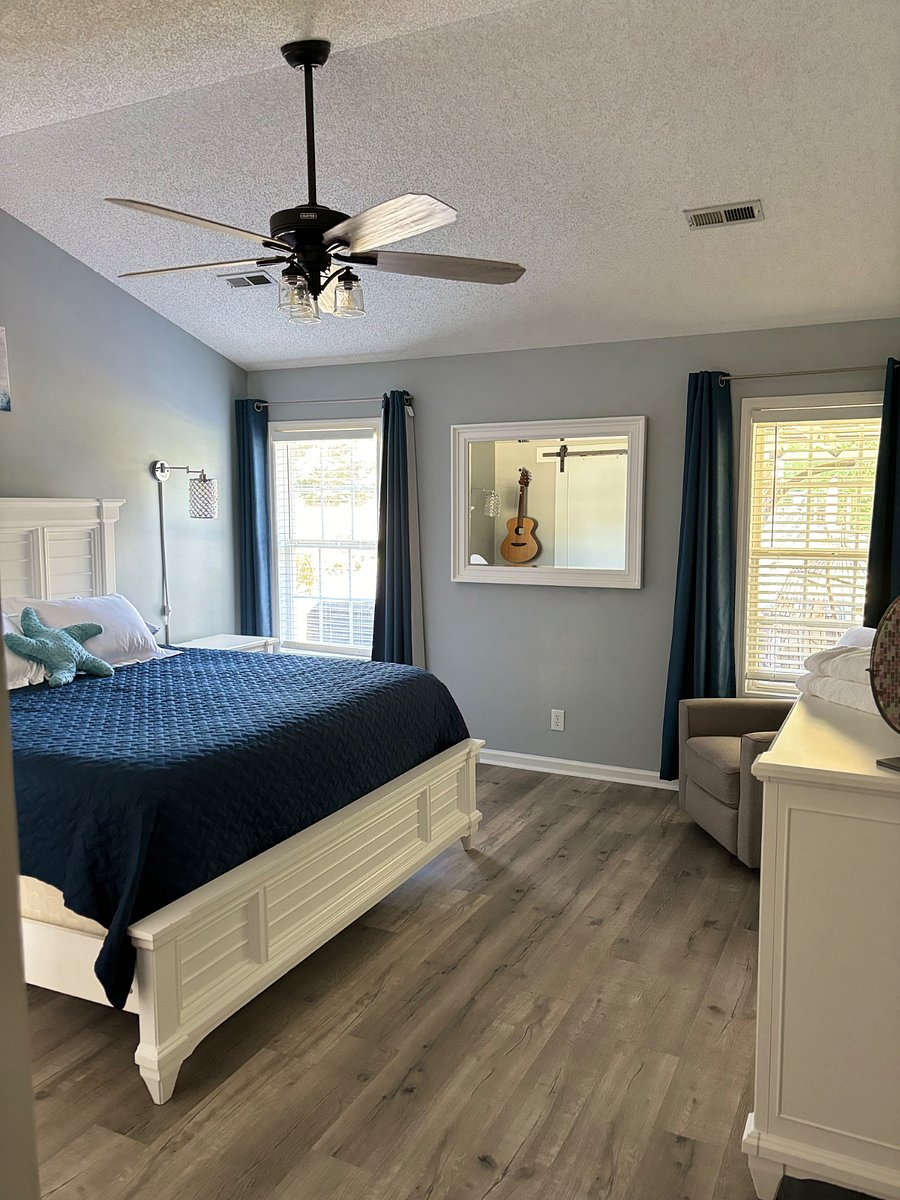 Master bedroom with king bed, smart TV nightstand x2, dresser, walk in closet, bathroom