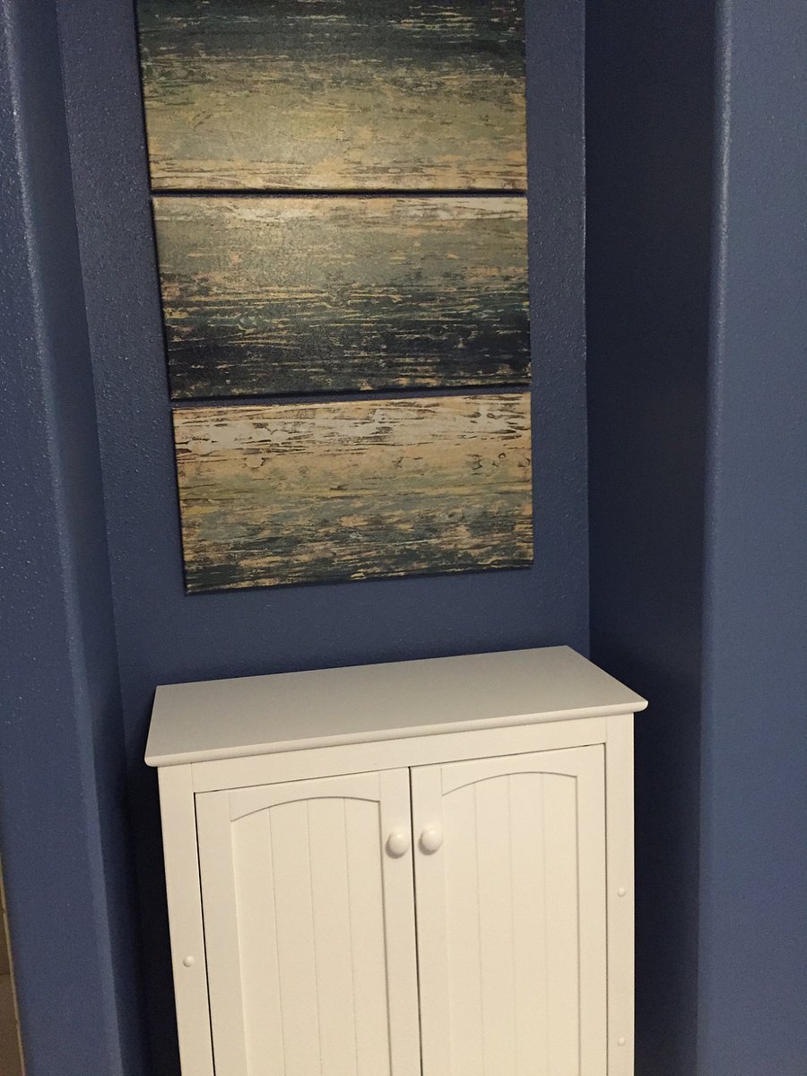 Bathroom cabinet w/ extra towels, toilet paper, etc