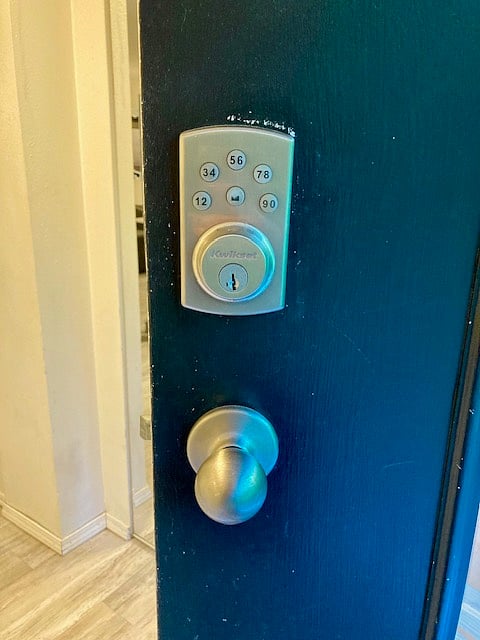 Keyless entry with your own, private code. The photo looks green, but the door is actually charcoal.