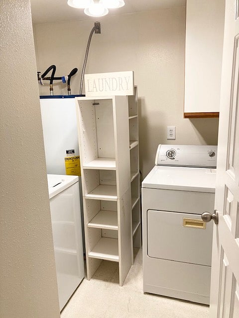 Private laundry room with storage, ironing board