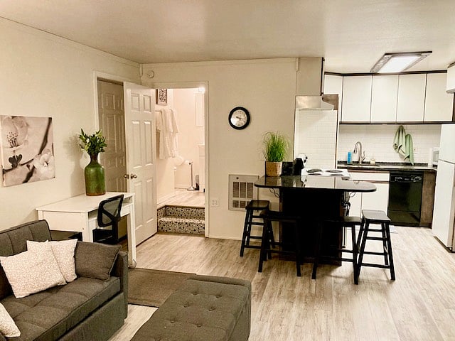Living room from the fireplace, including granite eating bar