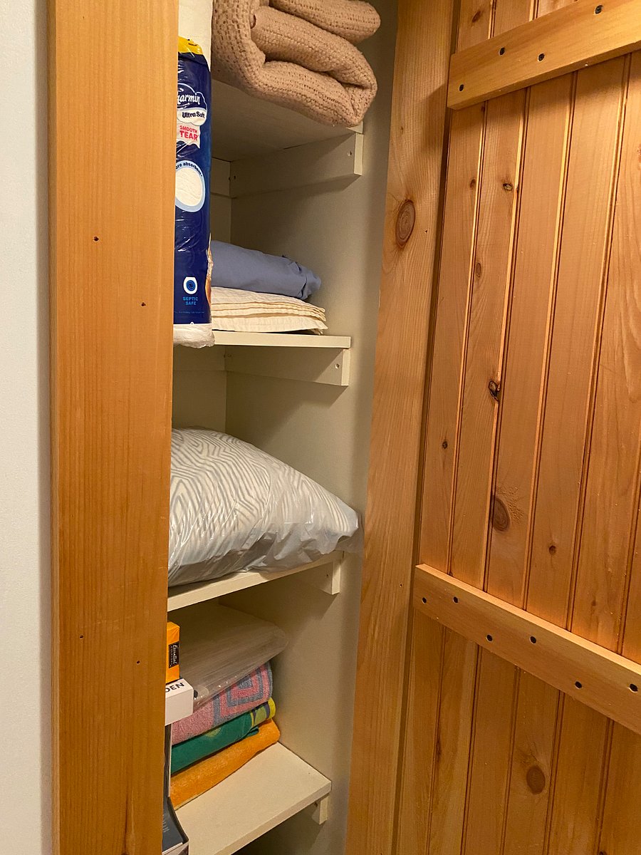 one of 3 closets with iron, extra blankets, beach towels and light bulbs,