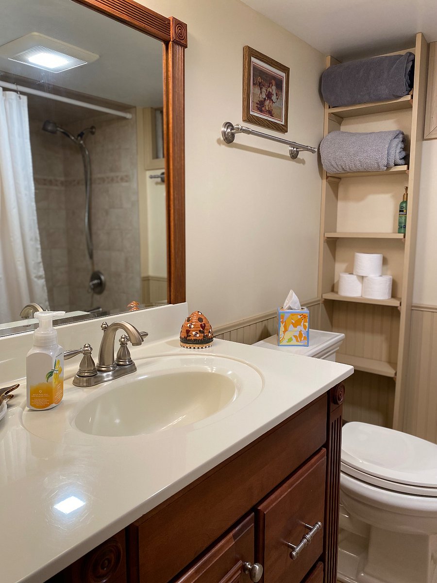 Full bathroom with storage, blow dryer, starter toiletries, towels