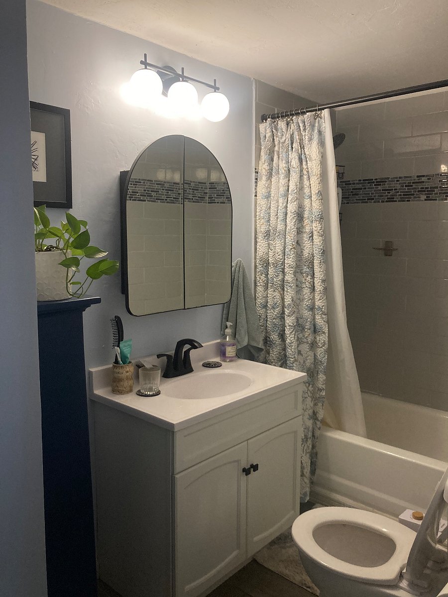 Shared bathroom -- linens provided for tenant, as well as shelves for storage