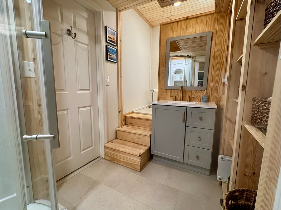 Sink and mirror. Stairs up to toilet.