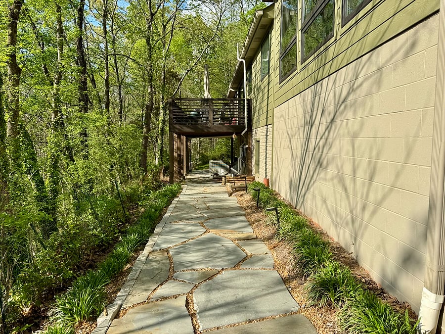 Flagstone walkway between driveway and the apartment entrance.
