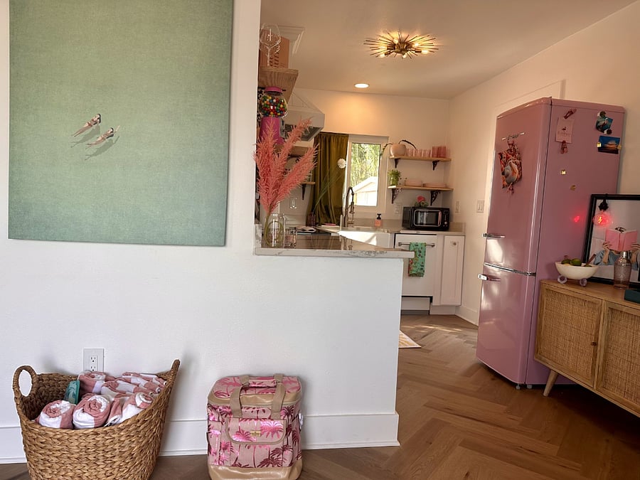 This kitchen is tickled pink with personality and fully equipped for a convenient and comfortable stay.