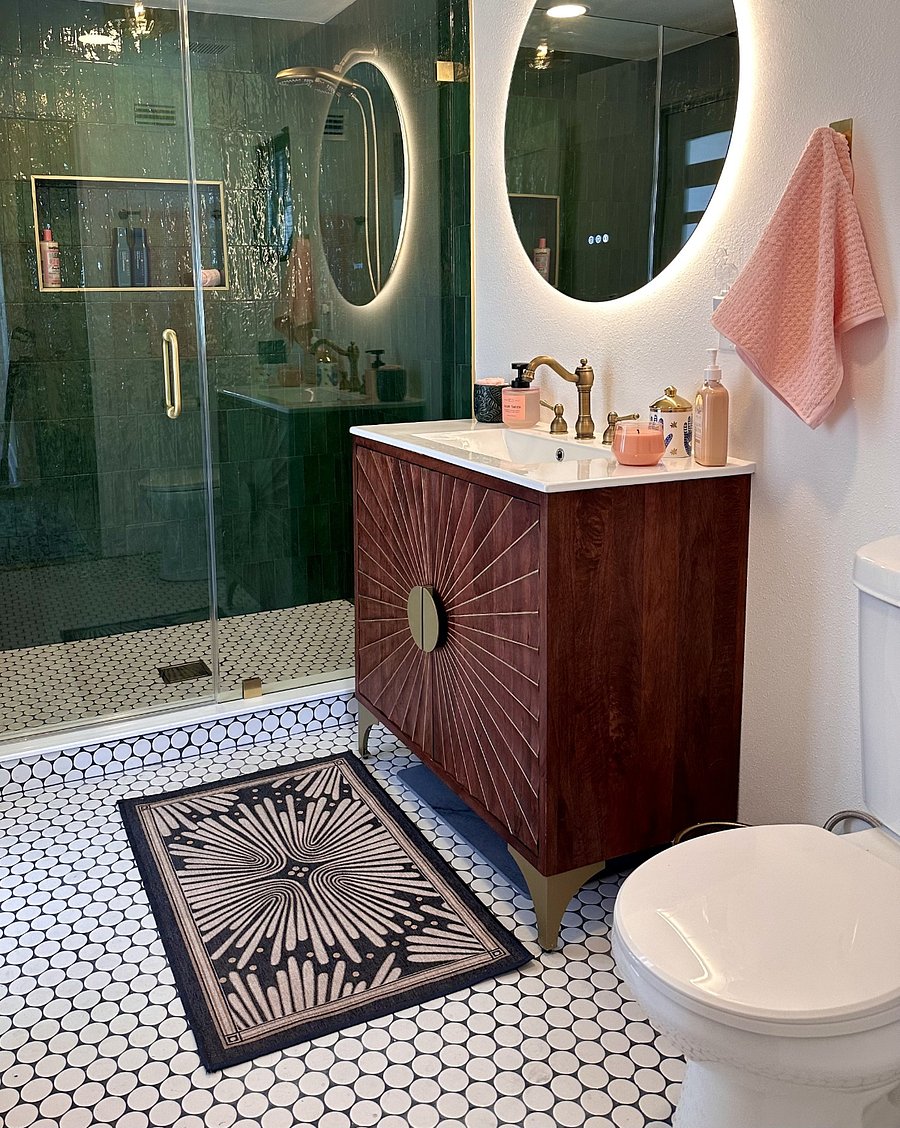 Bright, spa-inspired bathroom with a spacious walk-in glass shower, illuminated mirror, vintage-inspired vanity, and elegant designer touches throughout.